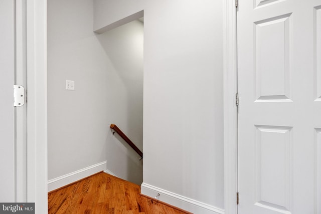 stairs with wood finished floors and baseboards