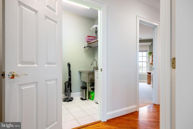 hallway with baseboards and wood finished floors