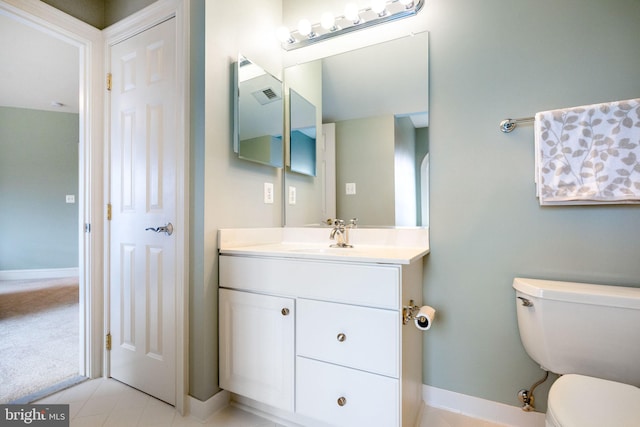 bathroom featuring visible vents, toilet, vanity, and baseboards