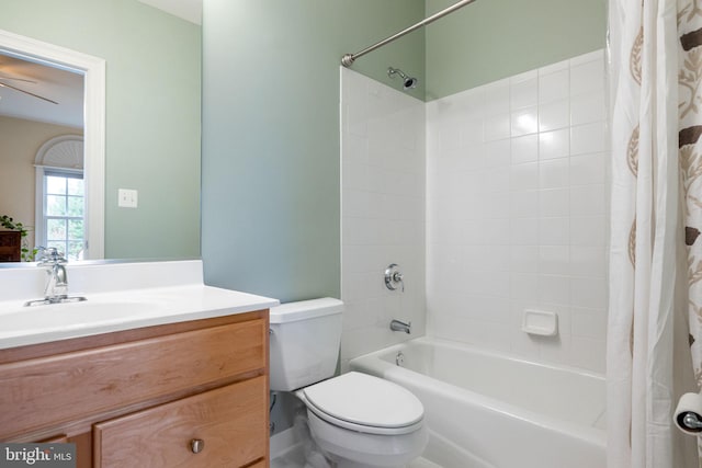 bathroom with toilet, shower / bath combo with shower curtain, and vanity