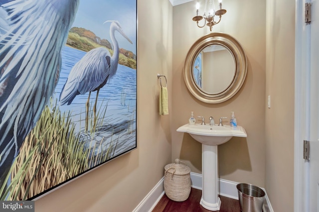 24537 Wave Maker Dr, Millsboro, DE 19966 - bathroom with a sink, wood finished floors, baseboards, and a chandelier