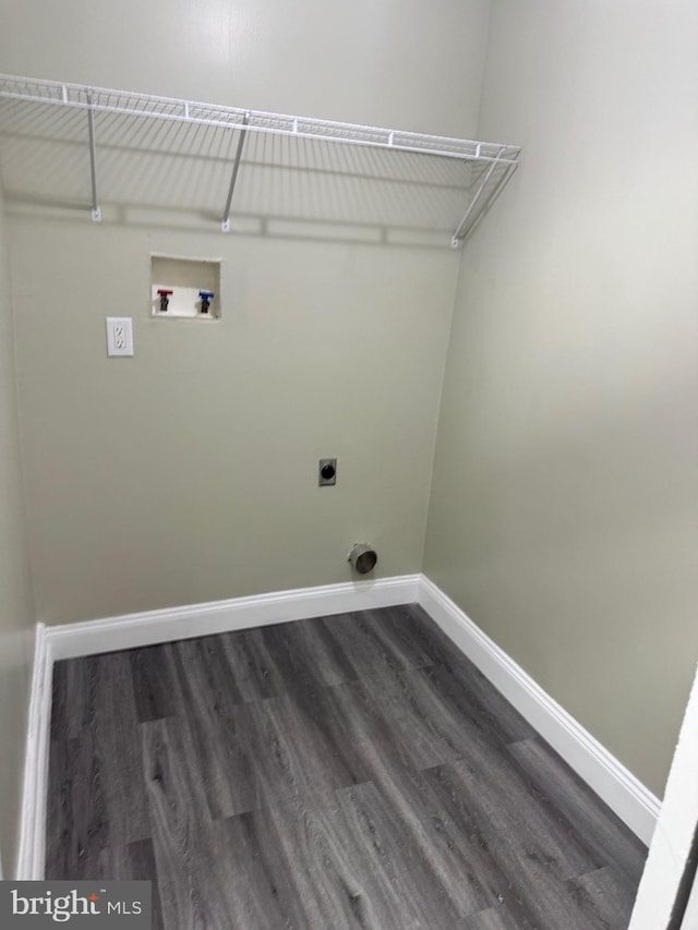 clothes washing area with baseboards, washer hookup, laundry area, electric dryer hookup, and dark wood-style flooring