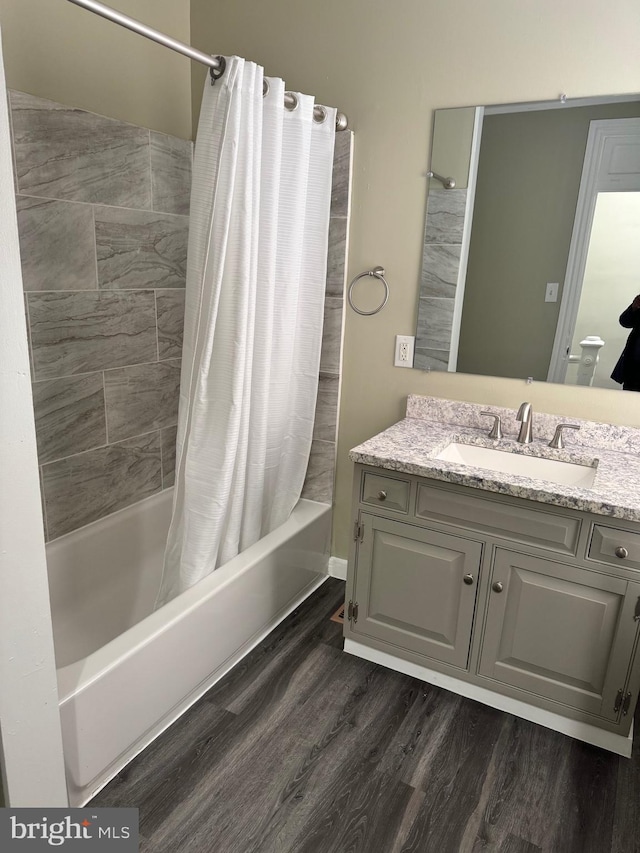 full bathroom with vanity, shower / bath combination with curtain, and wood finished floors