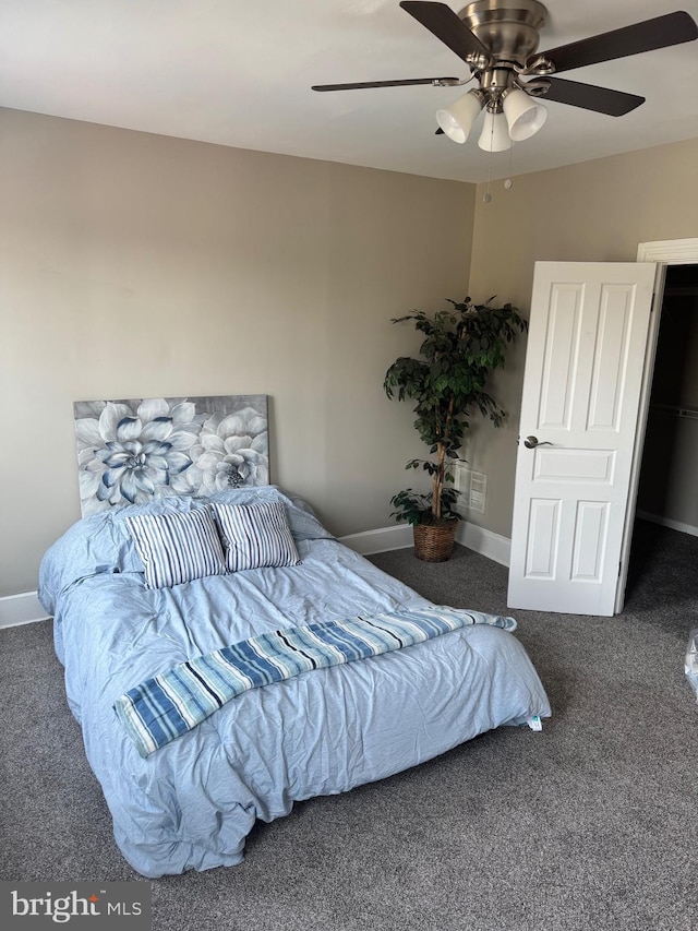 carpeted bedroom featuring ceiling fan and baseboards