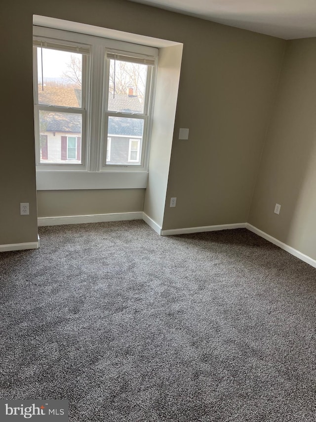 empty room with baseboards and carpet floors