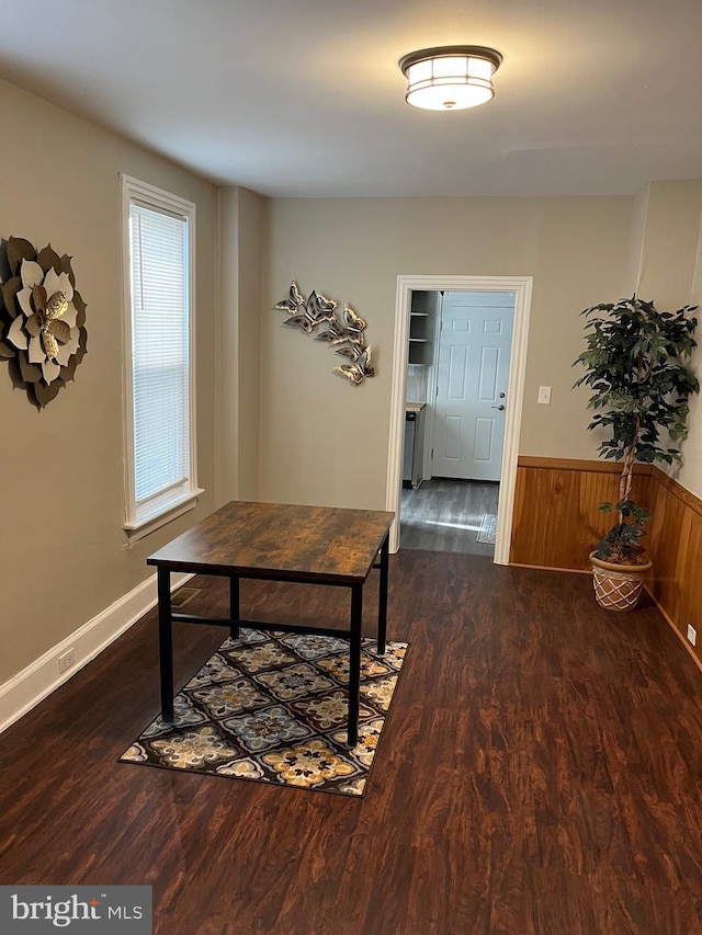 interior space featuring a wainscoted wall and wood finished floors