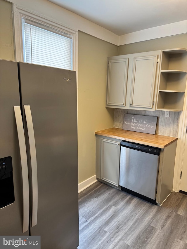 kitchen with baseboards, wooden counters, open shelves, dark wood-style flooring, and stainless steel appliances