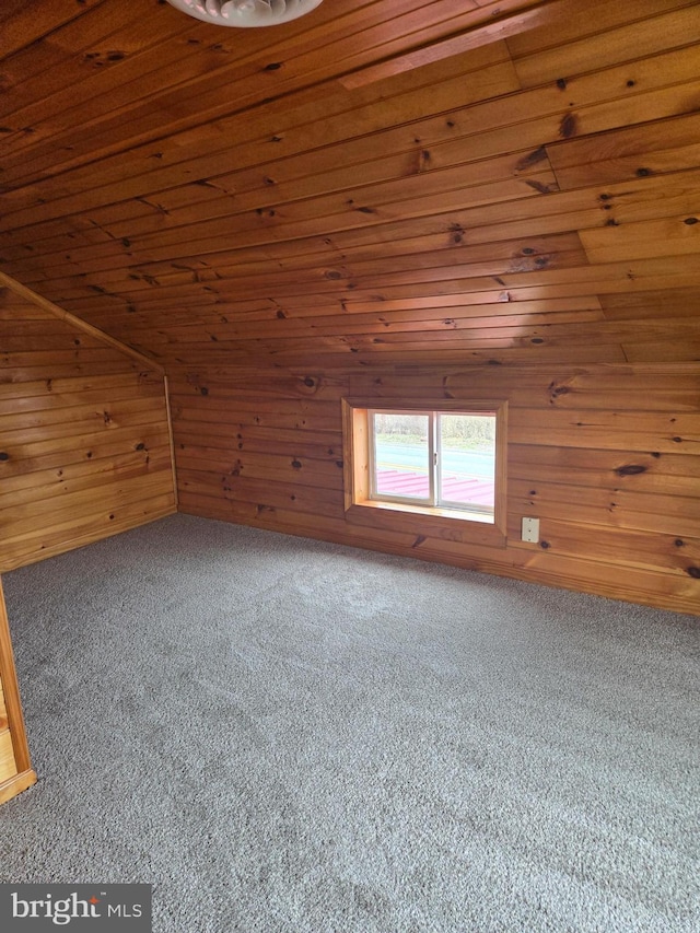 bonus room with lofted ceiling, wooden ceiling, wood walls, and carpet floors