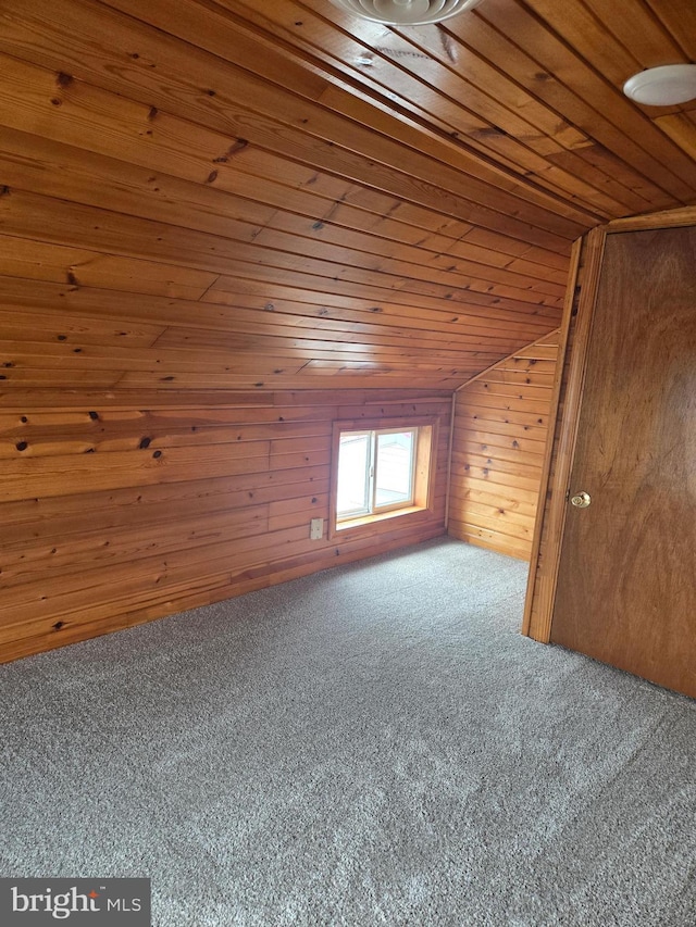 bonus room featuring carpet, wood ceiling, wooden walls, and vaulted ceiling