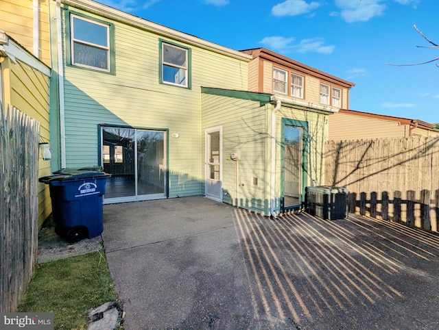 back of property featuring a patio area, fence, and central AC