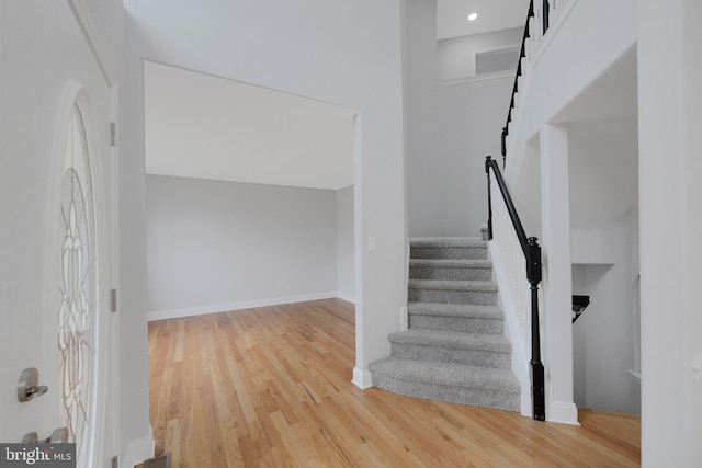 stairway with baseboards and wood finished floors