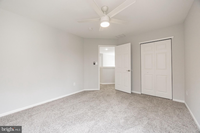 unfurnished bedroom with a closet, baseboards, carpet, and ceiling fan