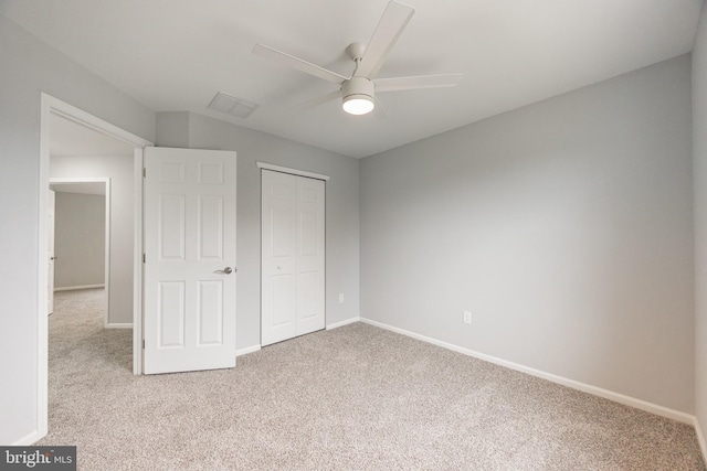 unfurnished bedroom featuring visible vents, baseboards, carpet, a closet, and a ceiling fan