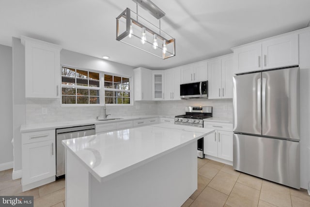 kitchen featuring a sink, stainless steel appliances, tasteful backsplash, and light tile patterned flooring