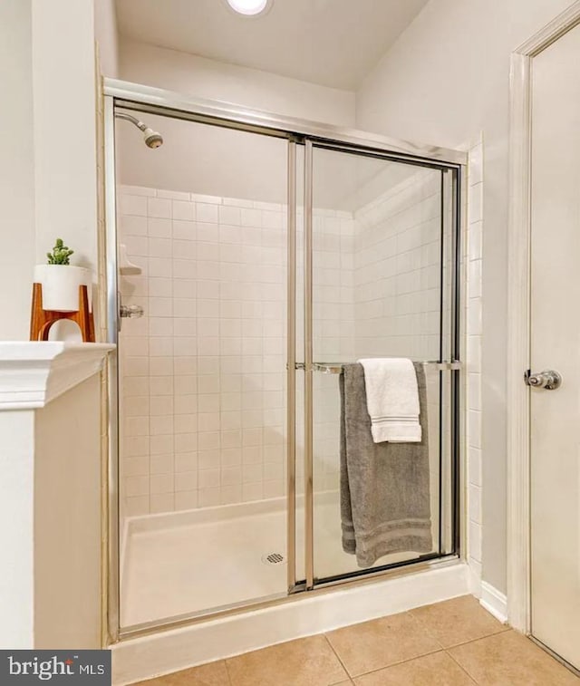 bathroom with tile patterned floors and a stall shower