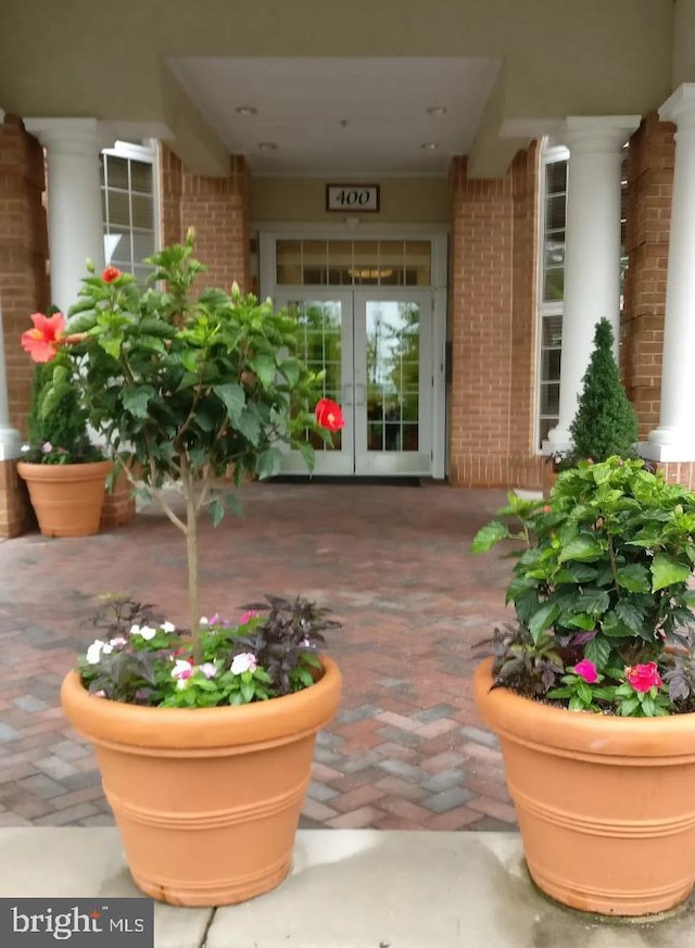 doorway to property with french doors and brick siding