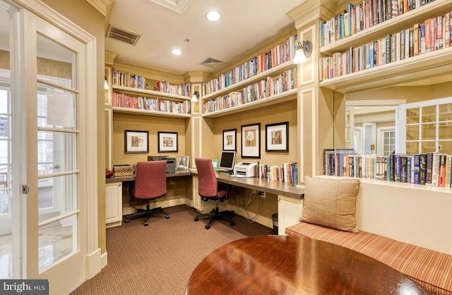 carpeted office space with recessed lighting, visible vents, baseboards, and built in study area