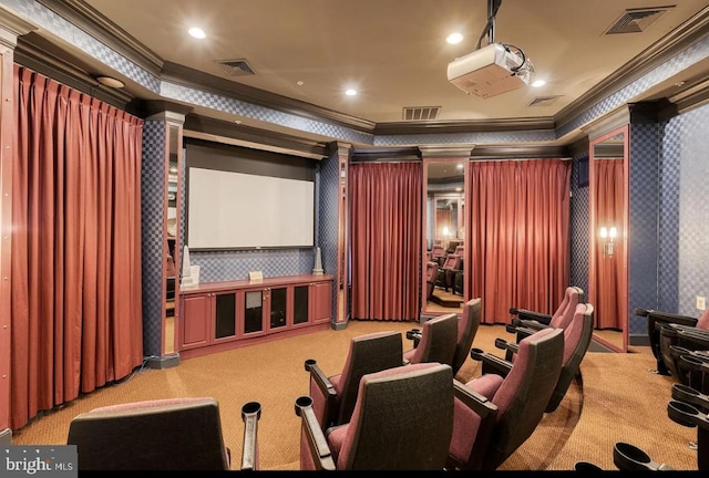 carpeted home theater with visible vents, crown molding, and wallpapered walls