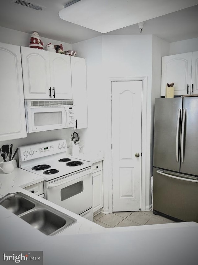 kitchen featuring a sink, white appliances, and white cabinets