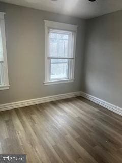 empty room with wood finished floors and baseboards