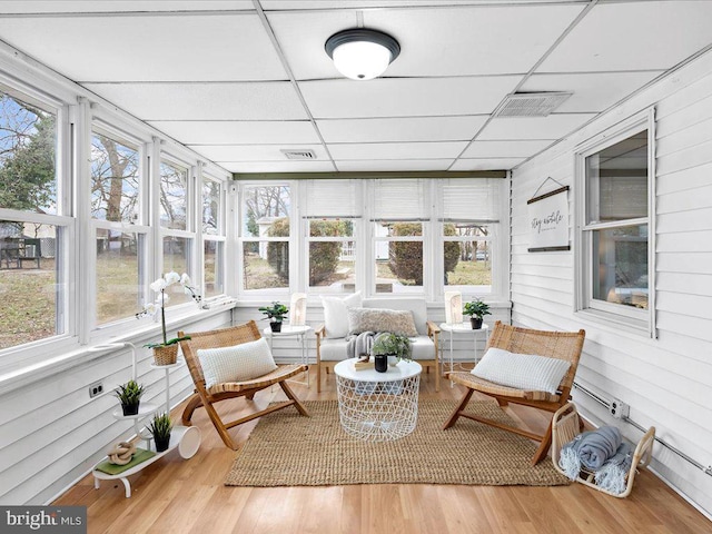 sunroom / solarium featuring a drop ceiling and visible vents