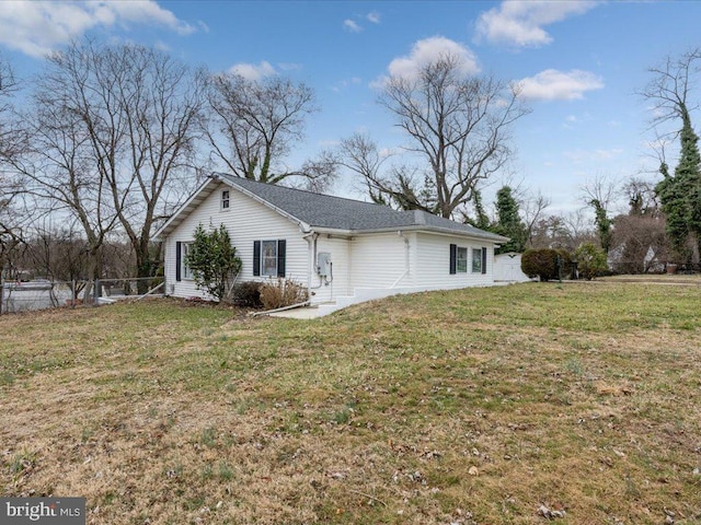 view of home's exterior featuring a yard and fence