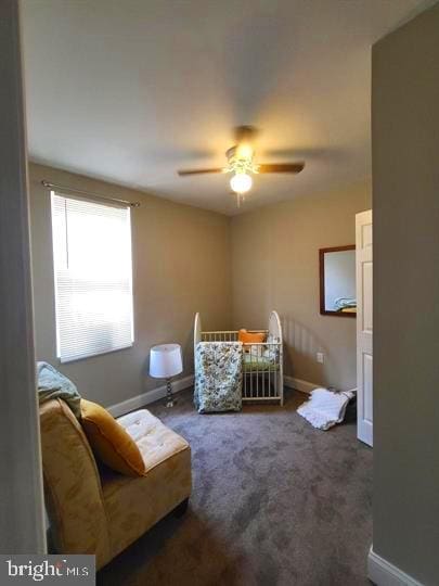 bedroom with baseboards, carpet flooring, and a ceiling fan