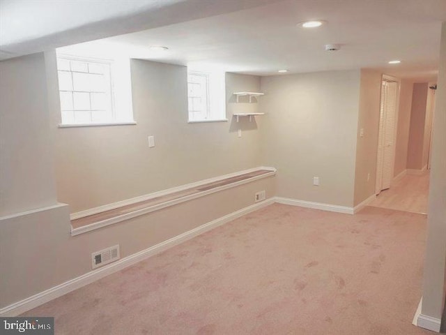 below grade area featuring baseboards, visible vents, recessed lighting, and carpet flooring