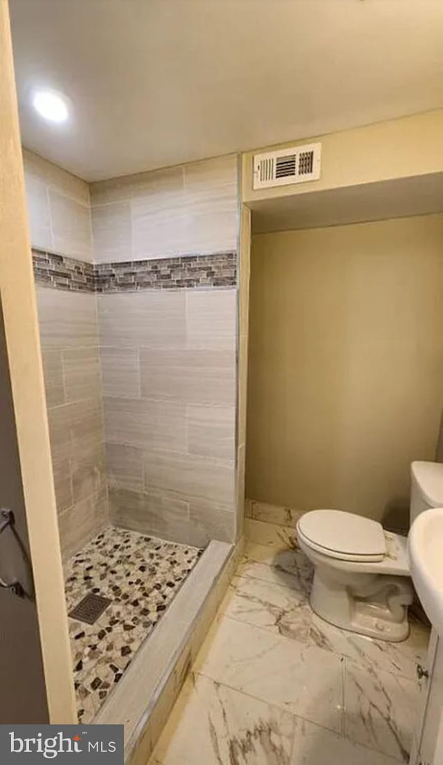 full bath with marble finish floor, toilet, a stall shower, and visible vents