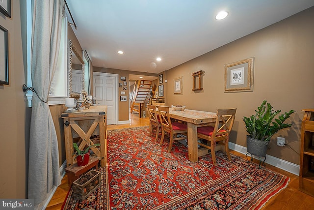 dining area with stairway, recessed lighting, light wood-style flooring, and baseboards