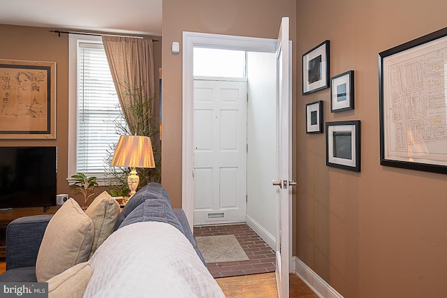 entryway with brick floor and baseboards