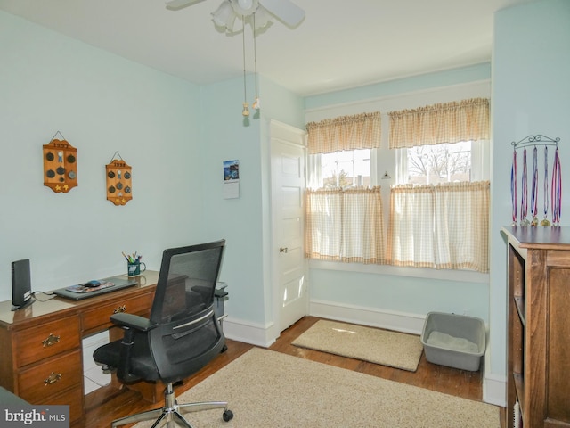 office with wood finished floors, a ceiling fan, and baseboards