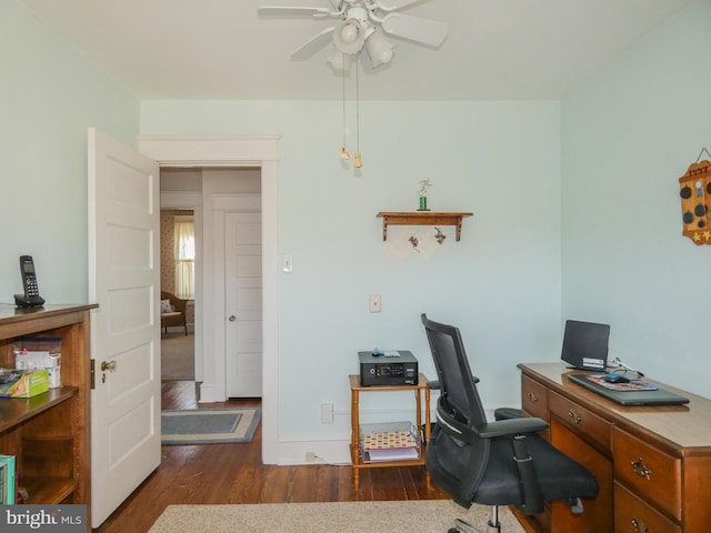 home office featuring ceiling fan, baseboards, and wood finished floors