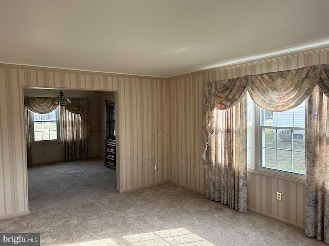 carpeted empty room featuring ornamental molding