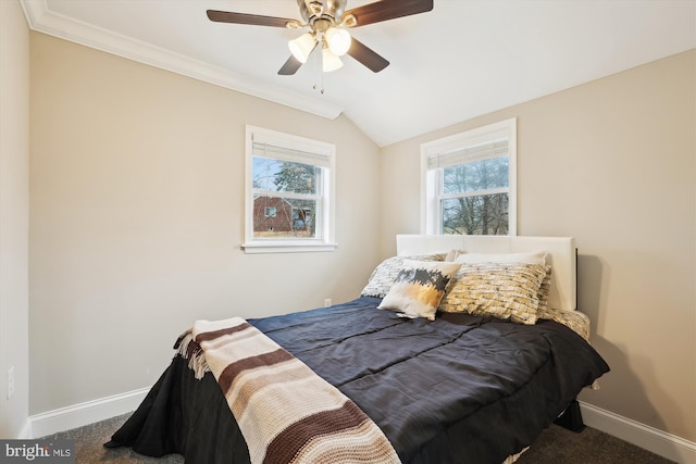 bedroom with crown molding, ceiling fan, baseboards, vaulted ceiling, and carpet flooring