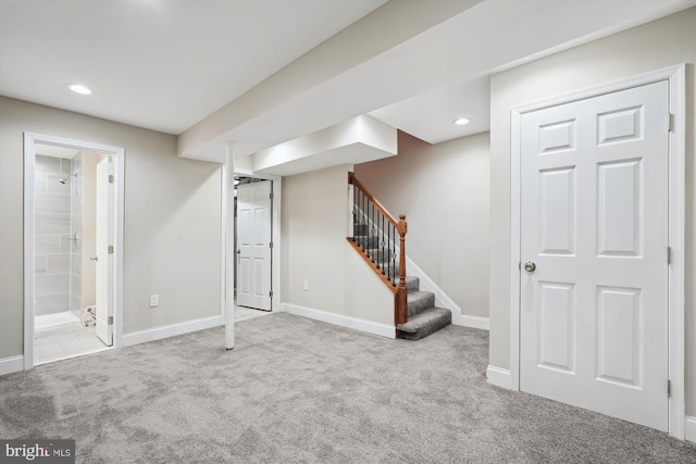 finished below grade area with stairway, recessed lighting, baseboards, and carpet