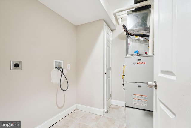 interior space with laundry area, electric dryer hookup, baseboards, and washer hookup