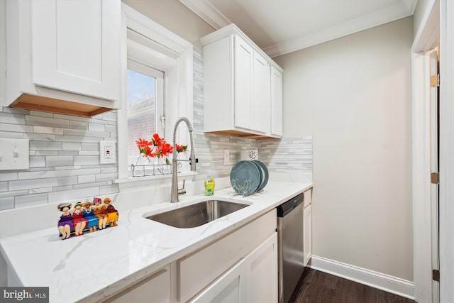 kitchen featuring dishwasher, ornamental molding, white cabinetry, and a sink