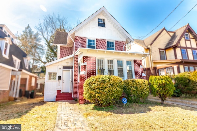 view of front facade featuring entry steps and brick siding