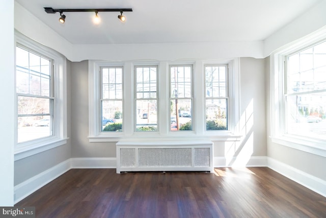 unfurnished sunroom with radiator