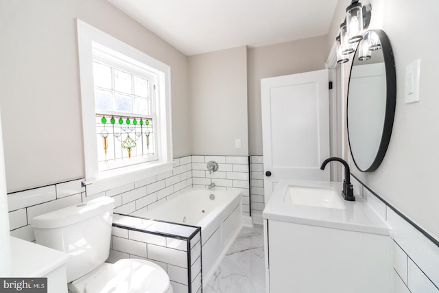 bathroom with vanity, toilet, marble finish floor, and a whirlpool tub