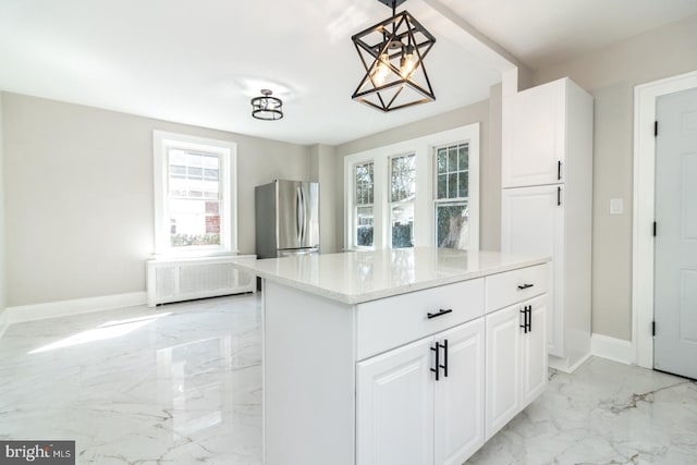 kitchen featuring white cabinets, radiator heating unit, marble finish floor, and freestanding refrigerator