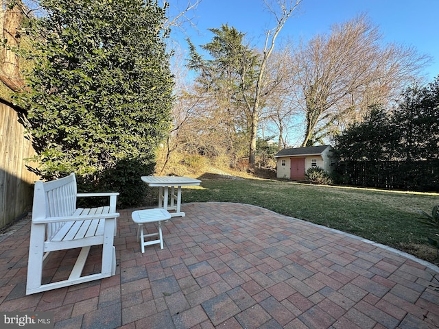 view of patio featuring an outdoor structure and fence