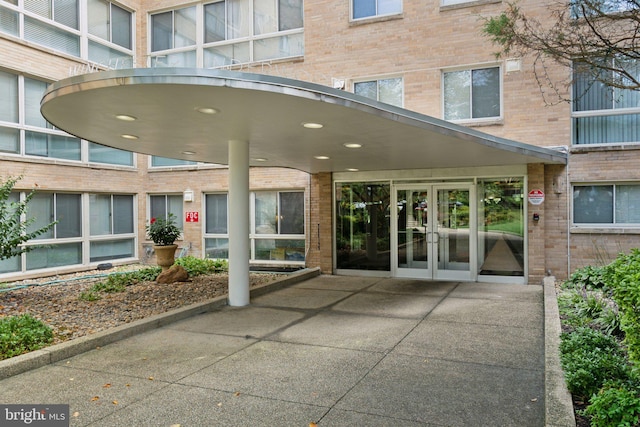 entrance to property with brick siding and french doors