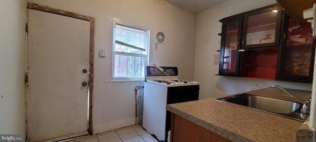 laundry room with light tile patterned floors and a sink