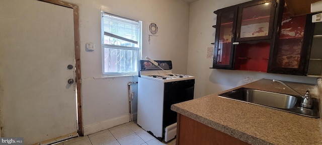 laundry room featuring a sink and light tile patterned floors