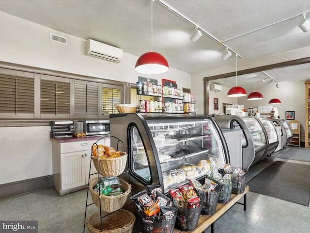 garage featuring a wall unit AC and visible vents