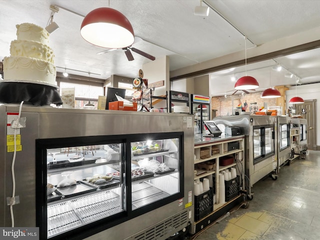 interior space featuring ceiling fan and rail lighting