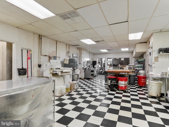 misc room with tile patterned floors, visible vents, and a paneled ceiling