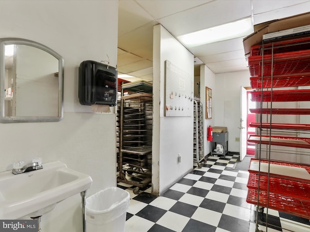 below grade area with tile patterned floors and a sink